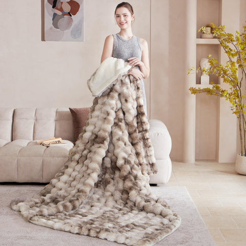 Serenhom vacuum-packed blanket next to hands to show fluff after washing