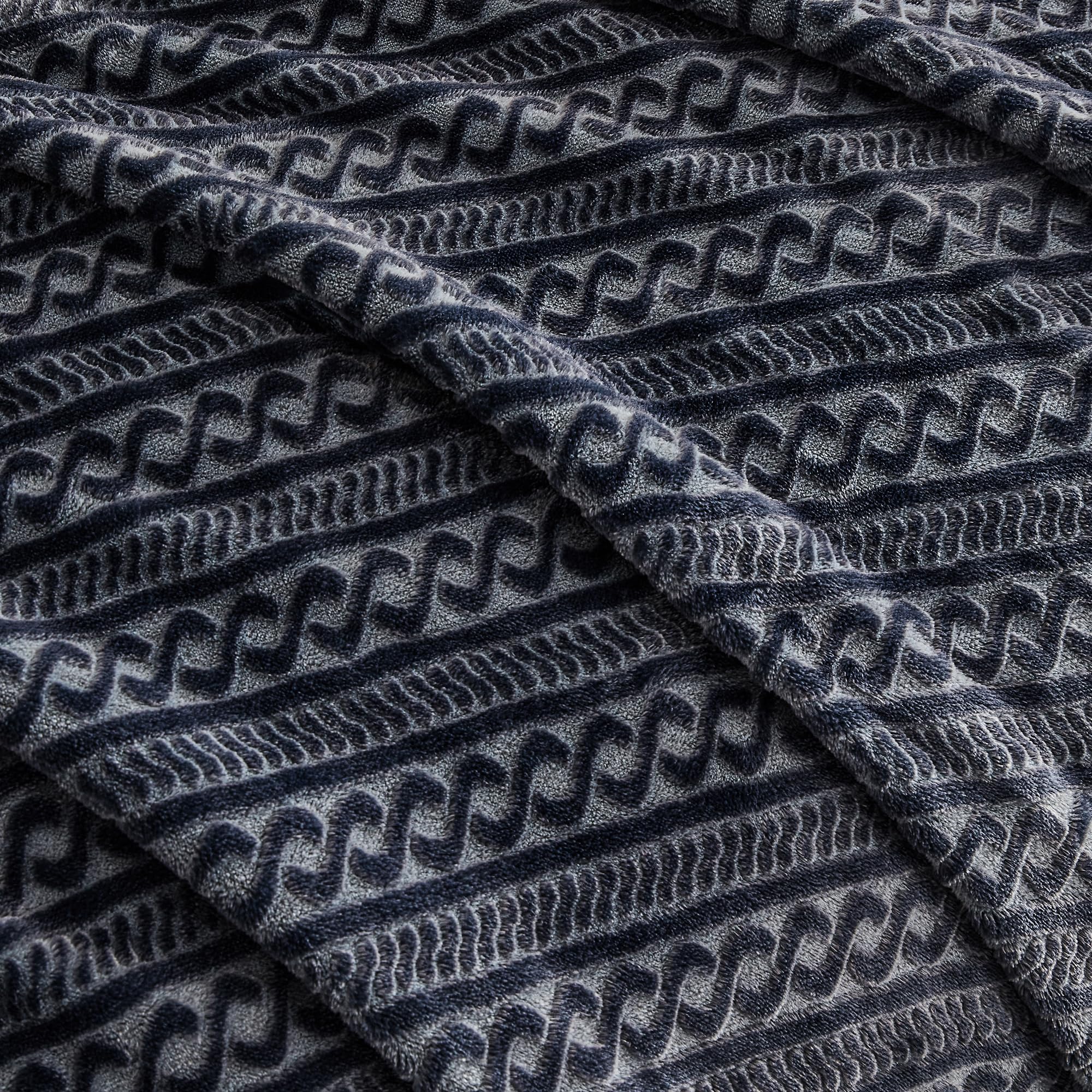 Serenhom family on couch with blanket illustrating comfort and multiuse versatility