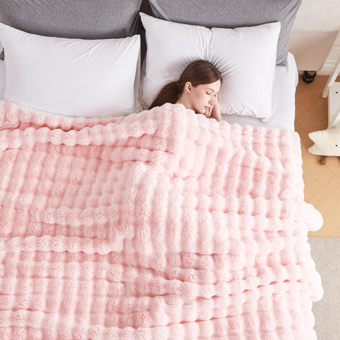 Serenhom blanket draped over reading chair with person using it for cozy warmth