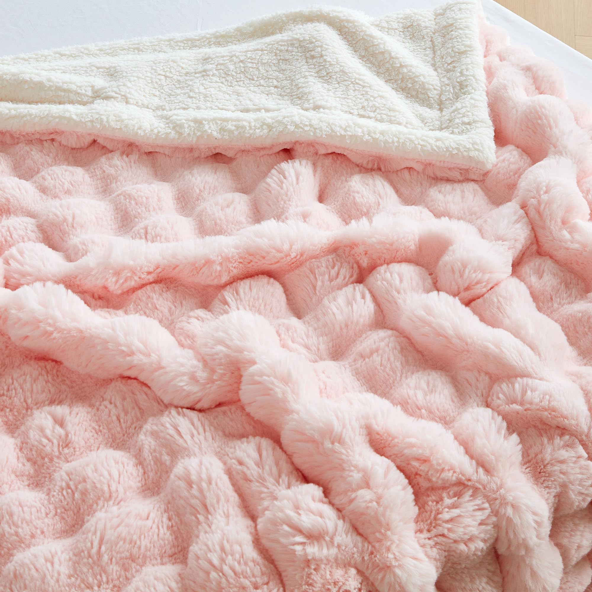Serenhom bubble pink blanket styled on bed to show color coordination and inviting comfort