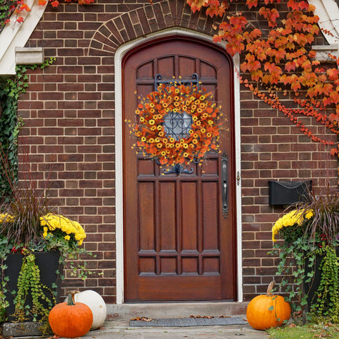 Sggvecsy wreath on wooden door creating welcoming entrance