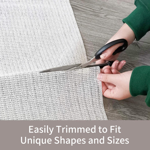 SHAREWIN rug pad being trimmed with scissors for a custom fit