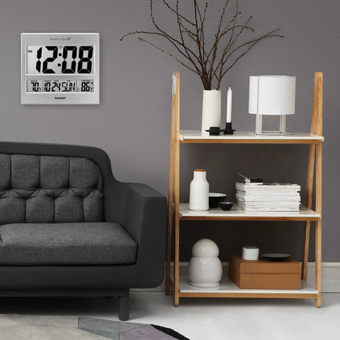 Sharp clock on kitchen wall demonstrating visible time and temperature monitoring