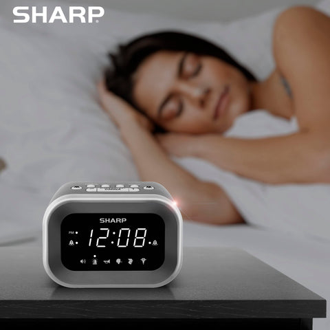 Sharp size comparison with smartphone showing compact footprint for small nightstands