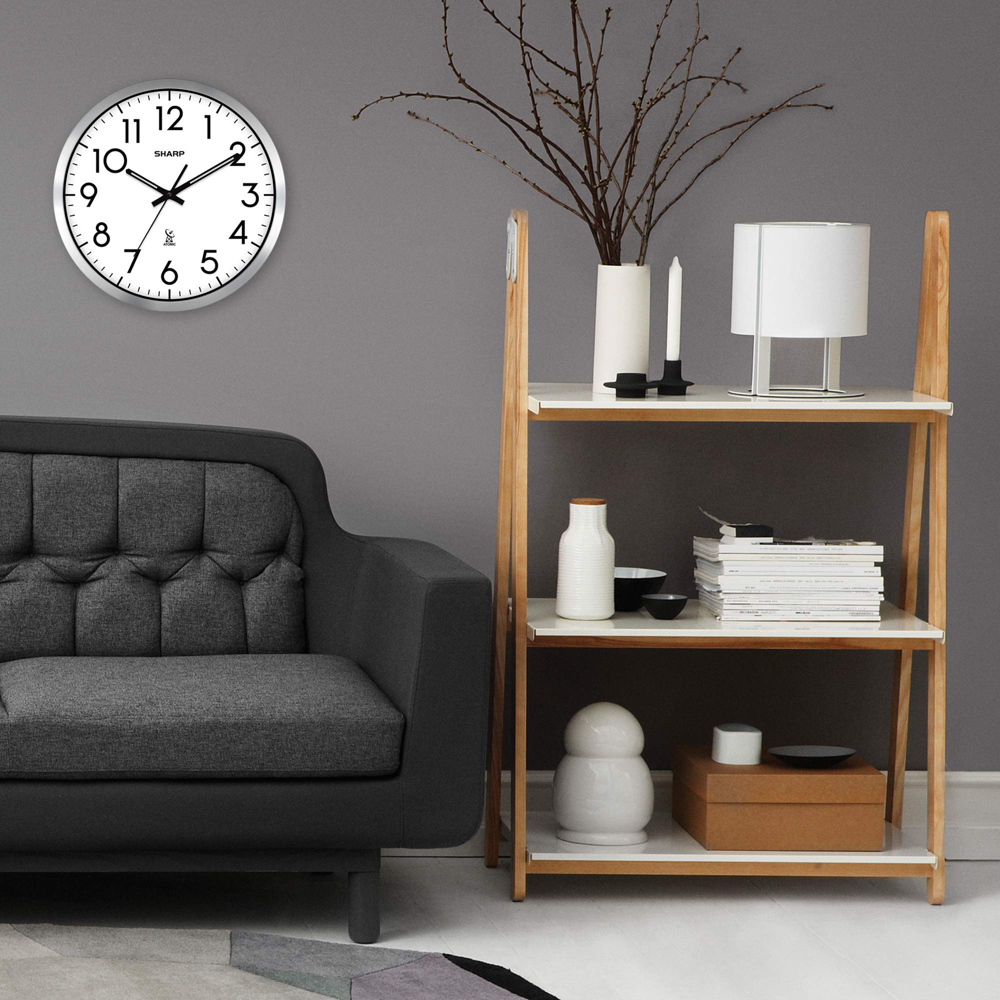 Sharp clock next to book showing scale and 12-inch size
