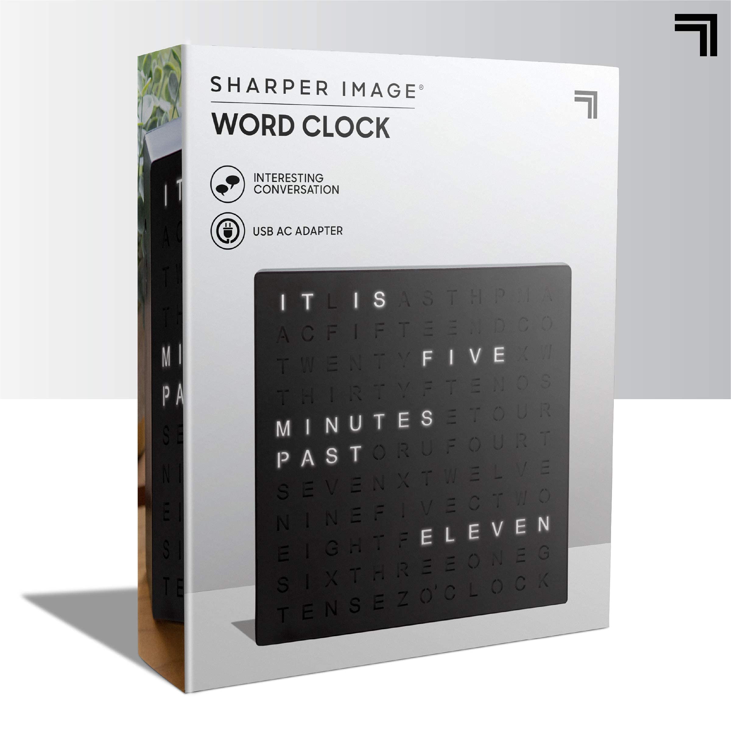 Sharper Image clock beside ruler showing compact 7.75 inch scale