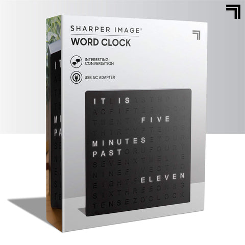 Sharper Image clock beside ruler showing compact 7.75 inch scale