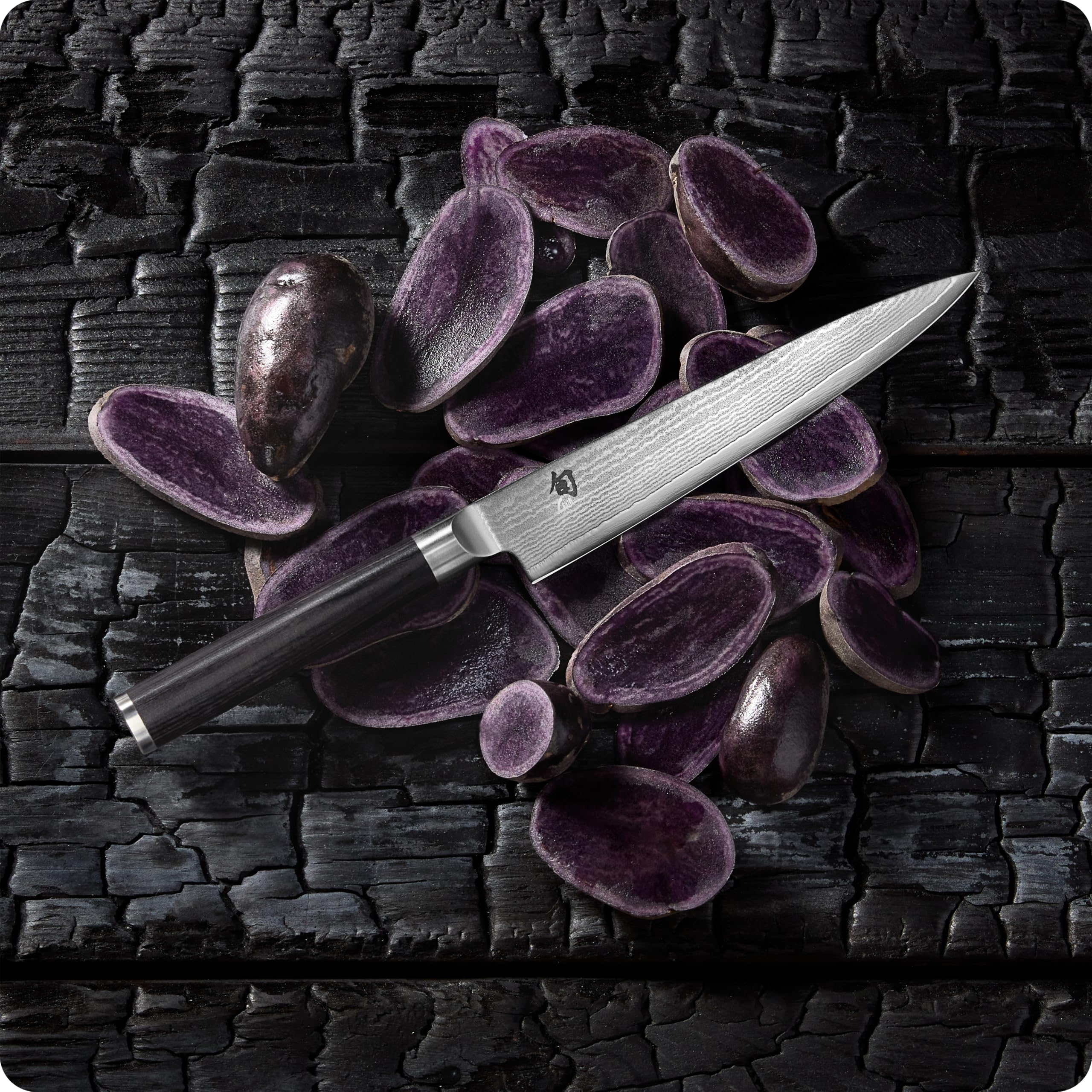Shun Classic 6" on a kitchen counter in use by cook to show versatile everyday utility