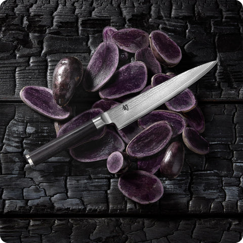 Shun Classic 6" on a kitchen counter in use by cook to show versatile everyday utility