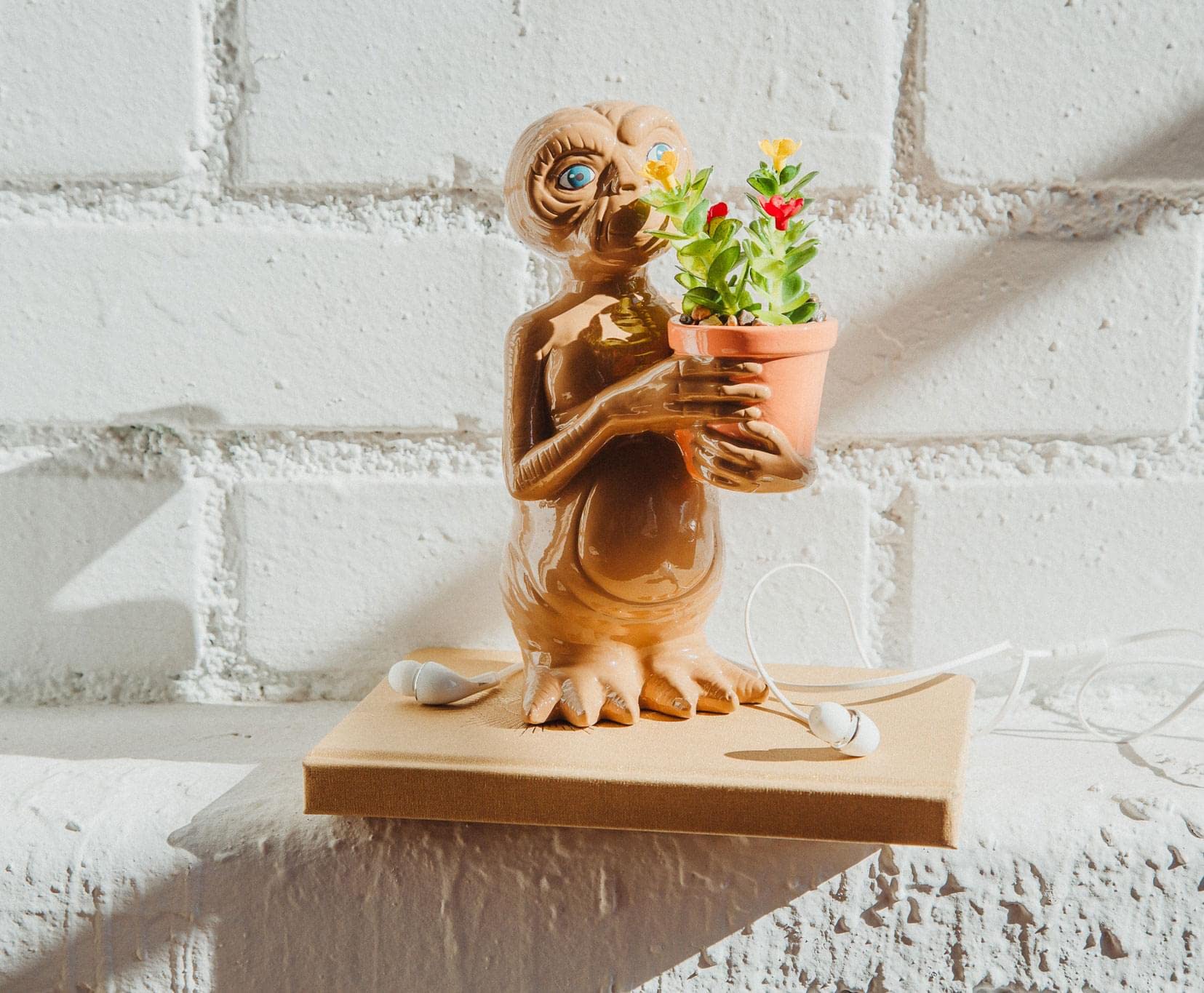 Silver Buffalo E.T. styled on a living room shelf among books and collectibles for visual interest