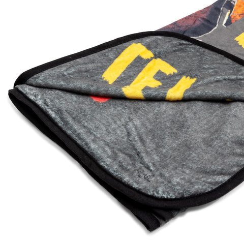 Silver Buffalo throw draped over a sofa conveying cozy gaming or movie-night warmth