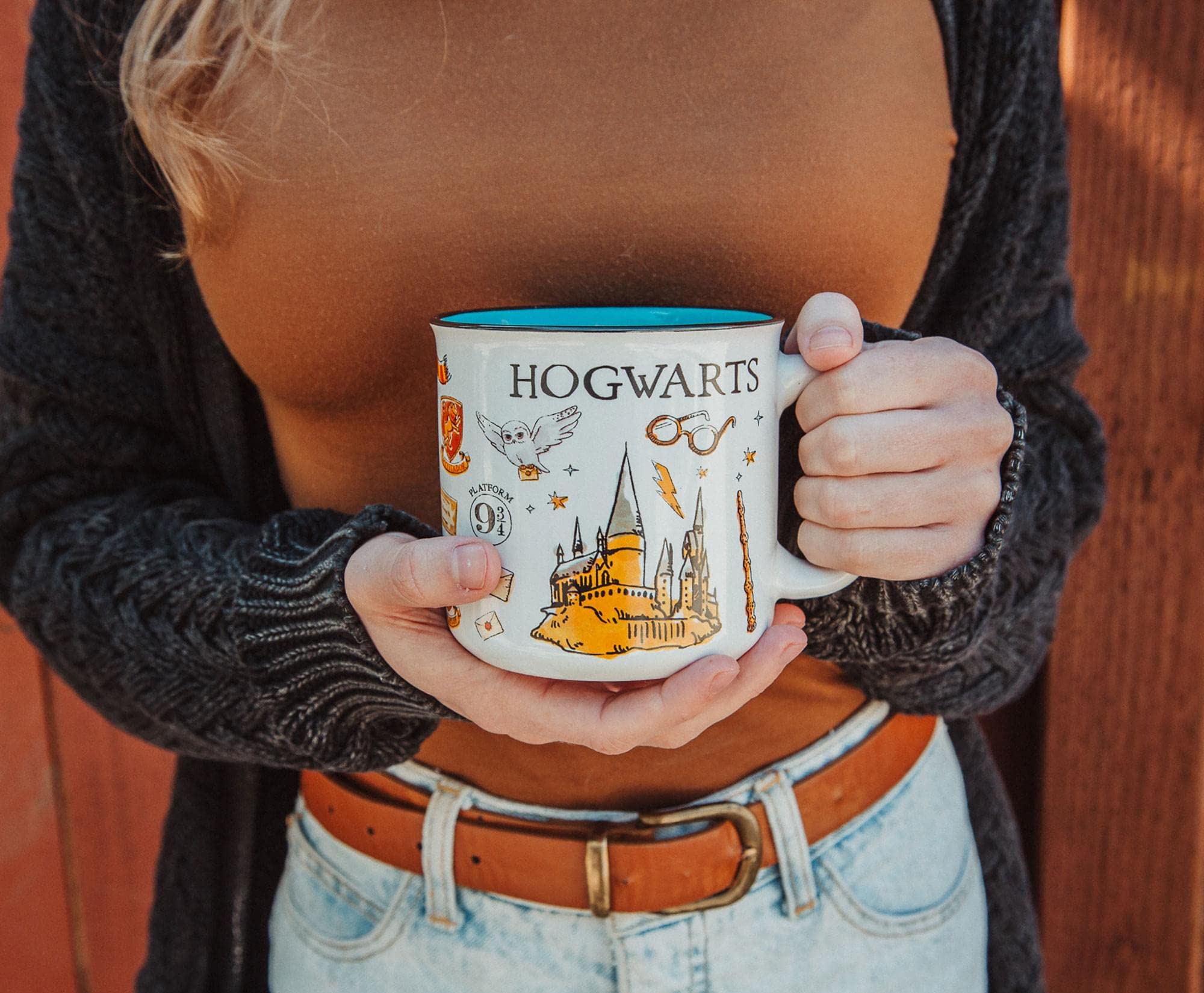 Silver Buffalo mug held in hand showing 20 oz scale and comfortable grip benefit
