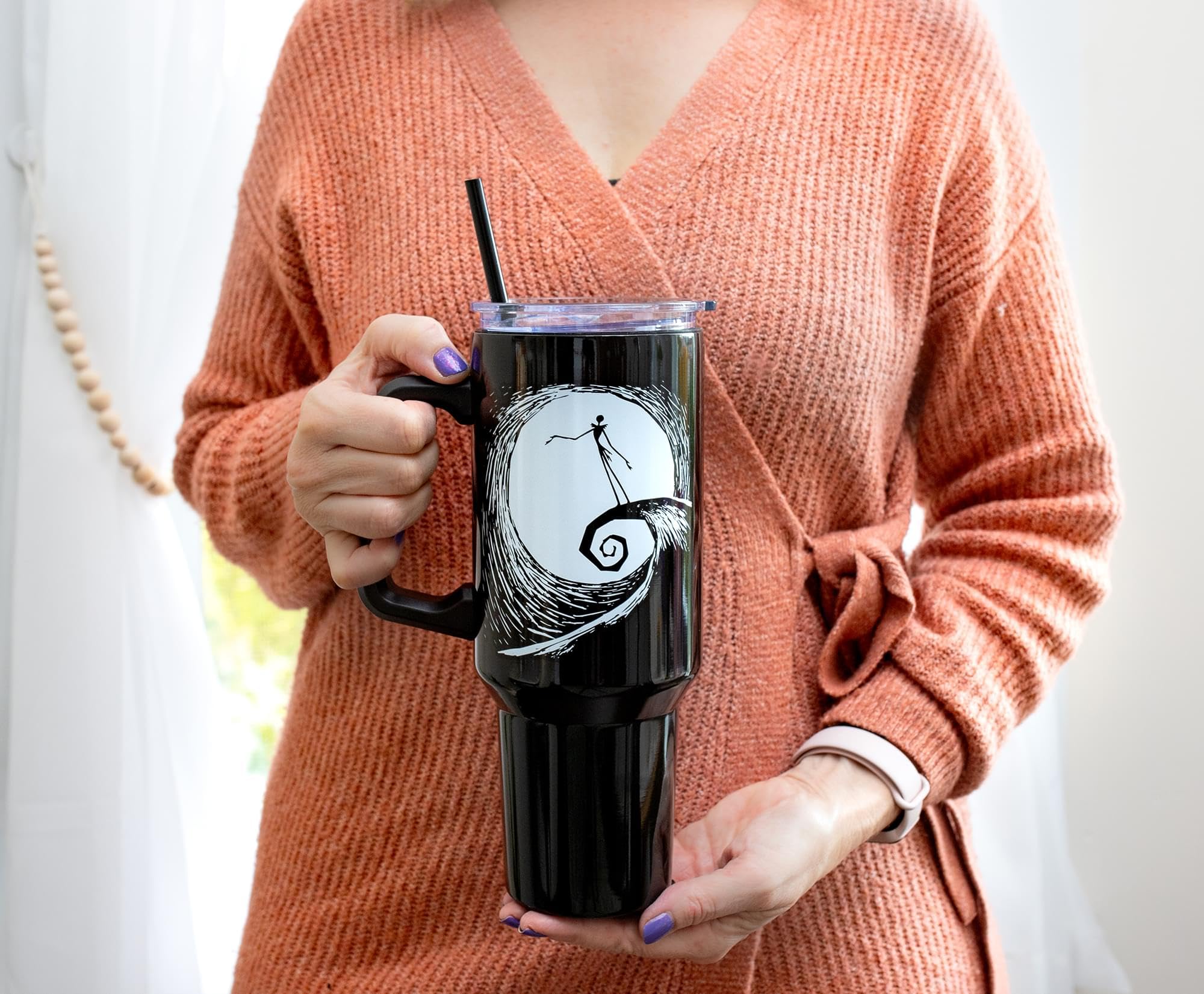 Silver Buffalo tumbler in hand with handle and straw, showing large capacity and portable use