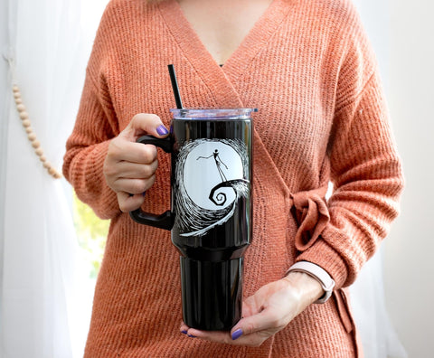 Silver Buffalo tumbler in hand with handle and straw, showing large capacity and portable use