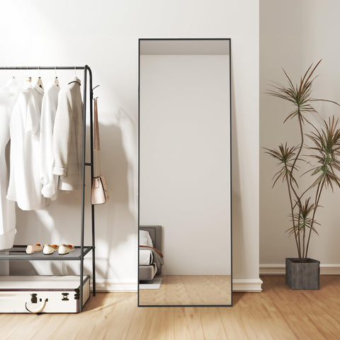 Simple Deluxe mirror next to person for size scale showing full-length coverage benefit