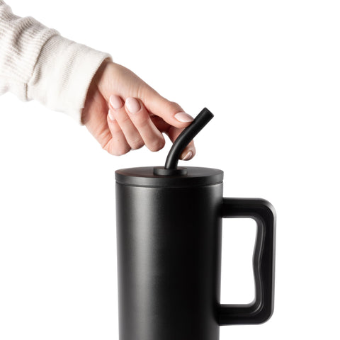 Simple Modern magenta tumbler on desk with silicone base preventing slips