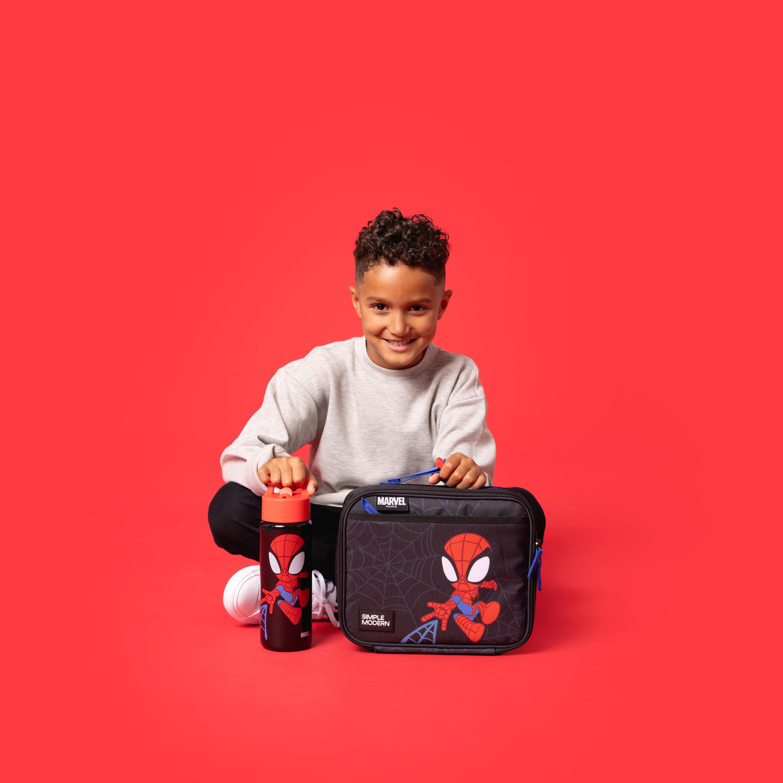 Simple Modern Spidey size comparison with toys demonstrating child‑friendly scale