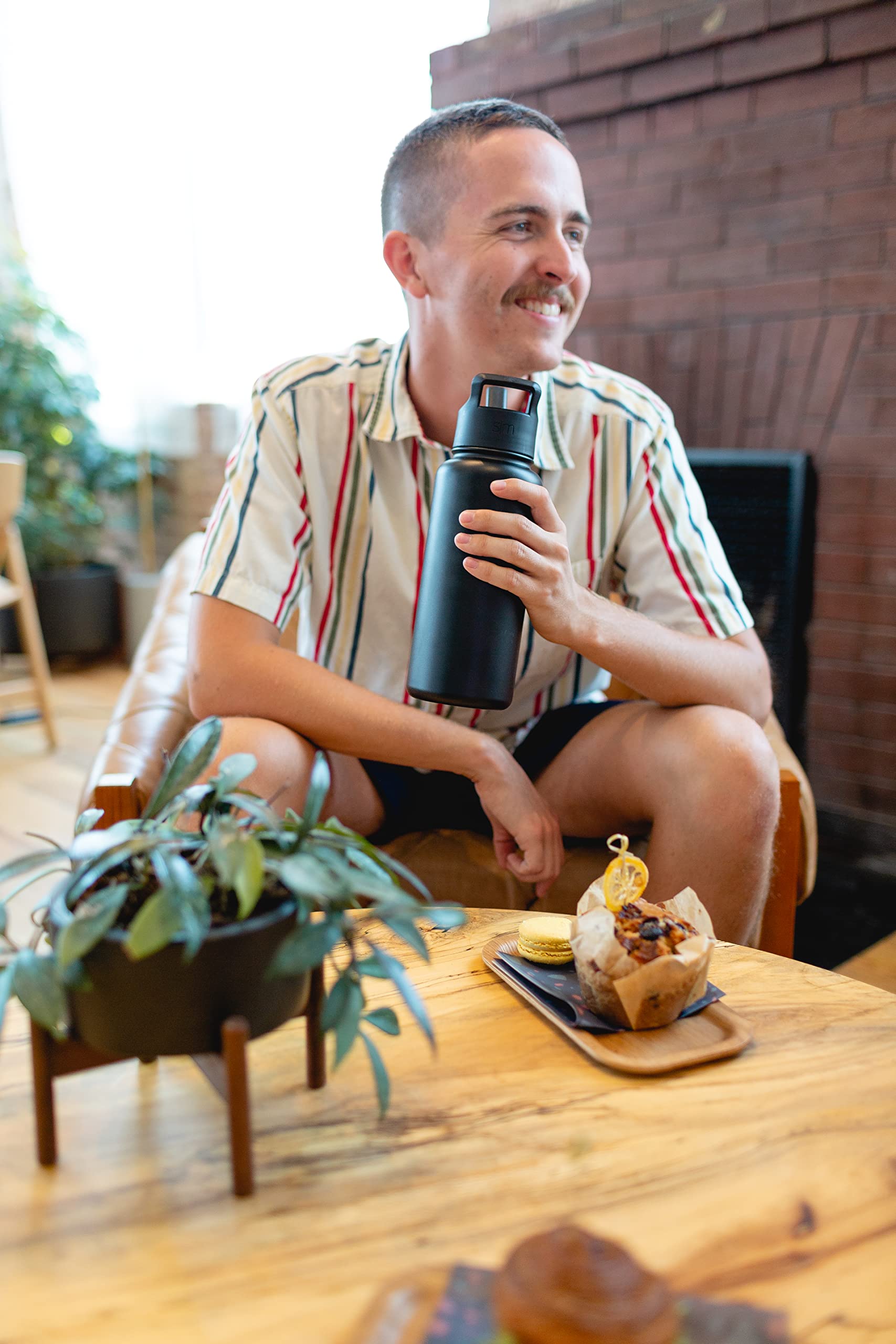 Simple Modern Summit held in hand for 32oz size comparison and capacity clarity