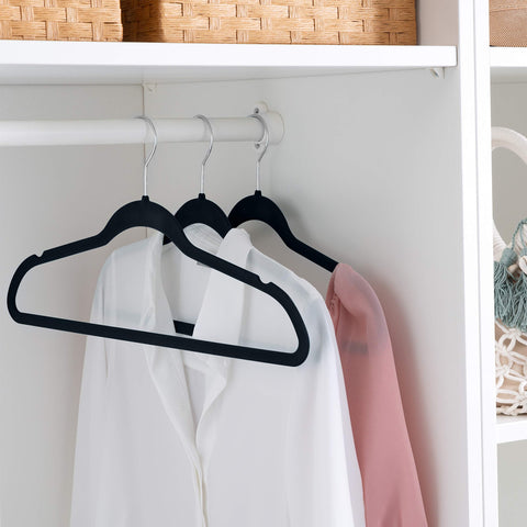 Simplify hanger held in hand showing slim profile for maximizing closet capacity