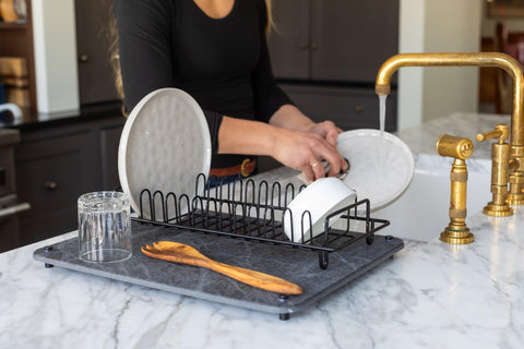 Siren Stone holding a plant saucer and pet bowl to prevent spills on counters