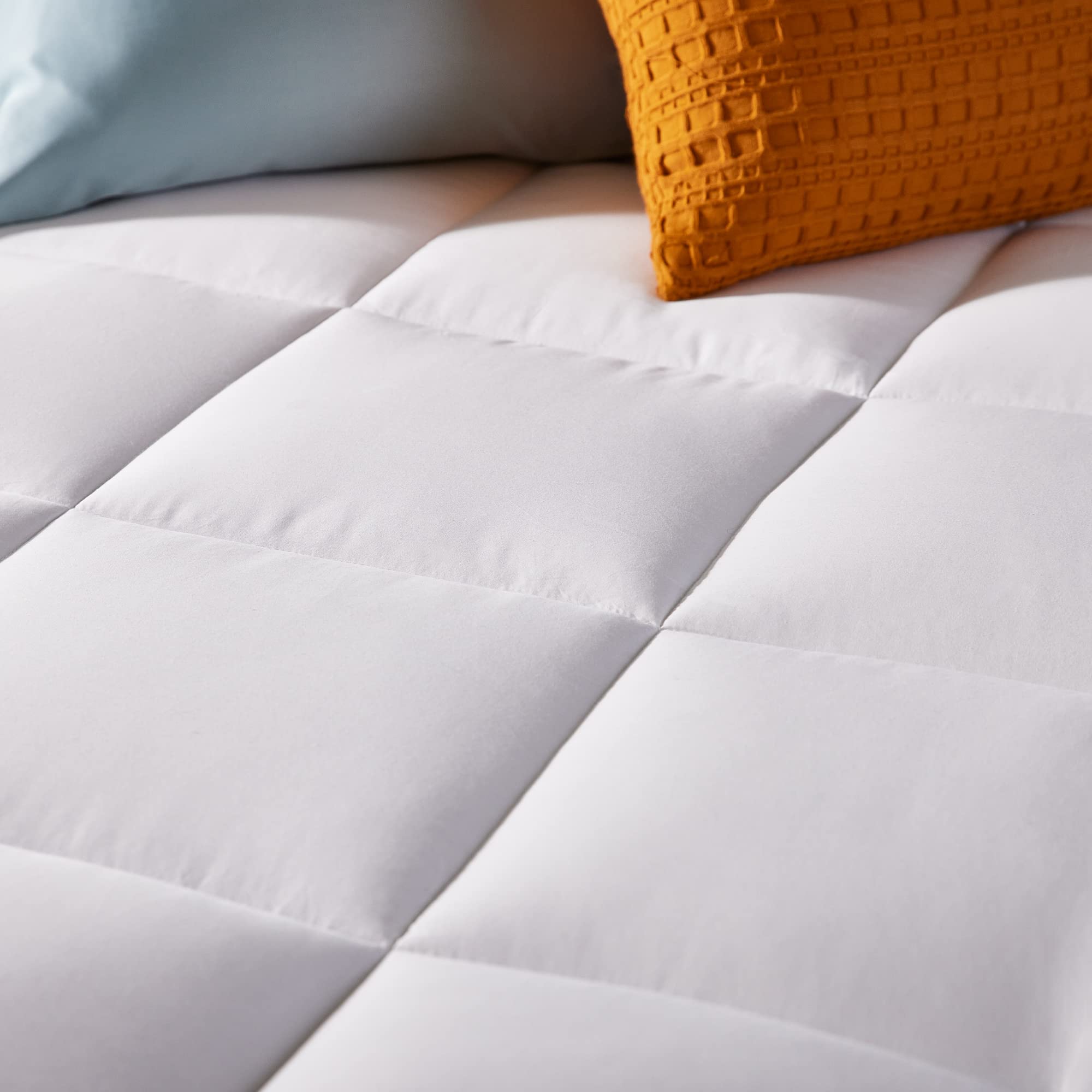 Sleep Innovations image of zippered removable cover being taken off for easy washing