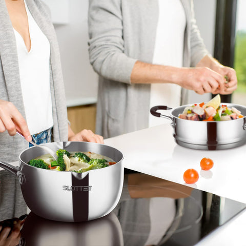 SLOTTET saucepan on kitchen counter being used to serve steamed vegetables to plate