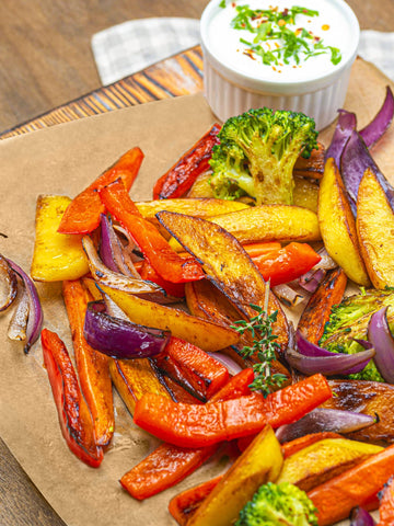 SMARTAKE sheet lining a roasting pan of vegetables to reduce scrubbing after cooking