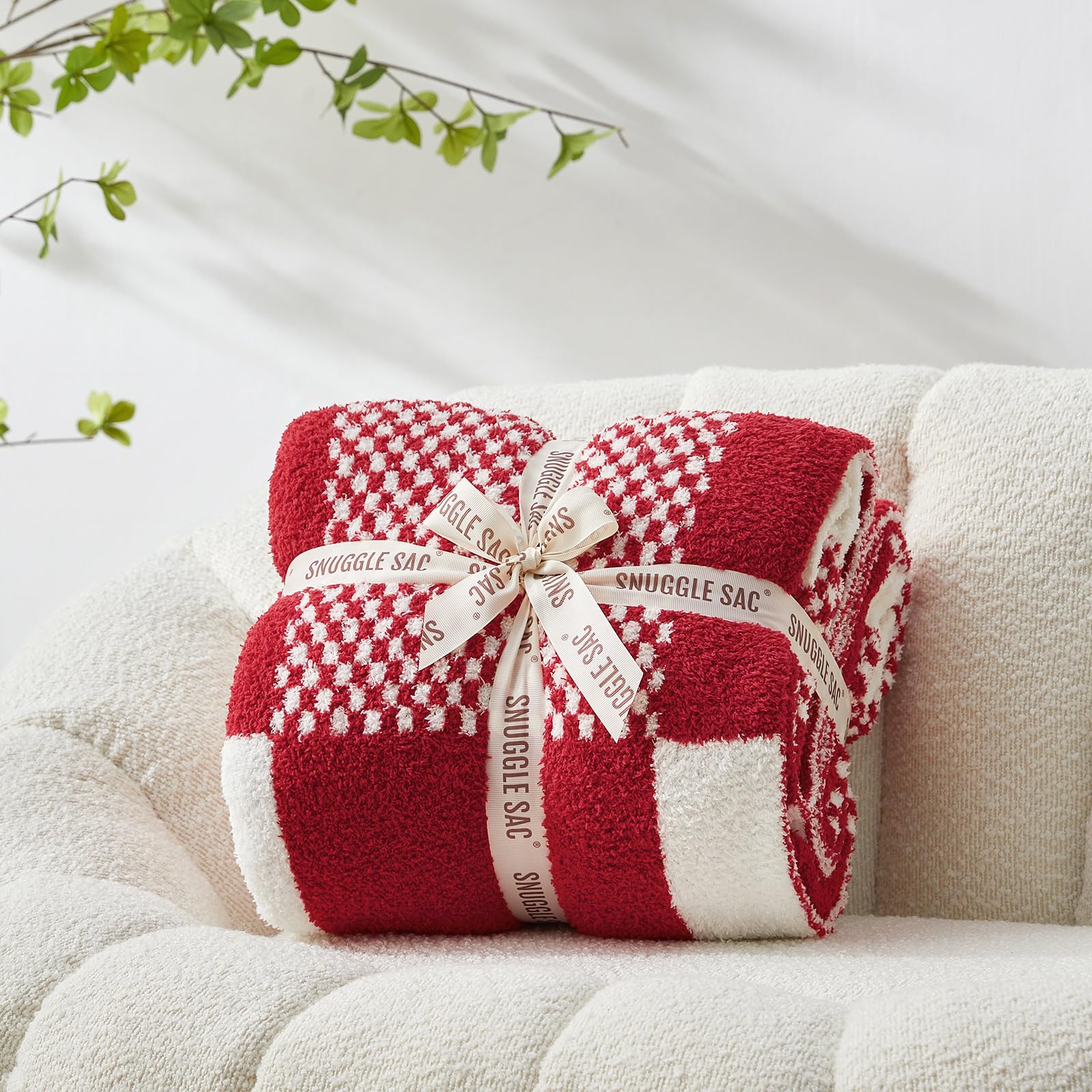 Snuggle Sac draped on sofa adding warmth and stylish red plaid accent