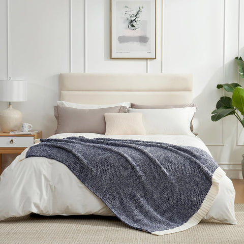 Snuggle Sac folded throw beside a book demonstrating compact storage