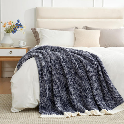 Snuggle Sac navy throw styled on bed providing layered bedroom warmth