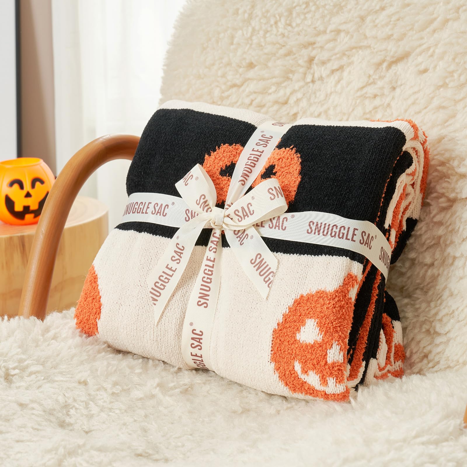 Snuggle Sac draped over sofa adding Halloween color and cozy warmth