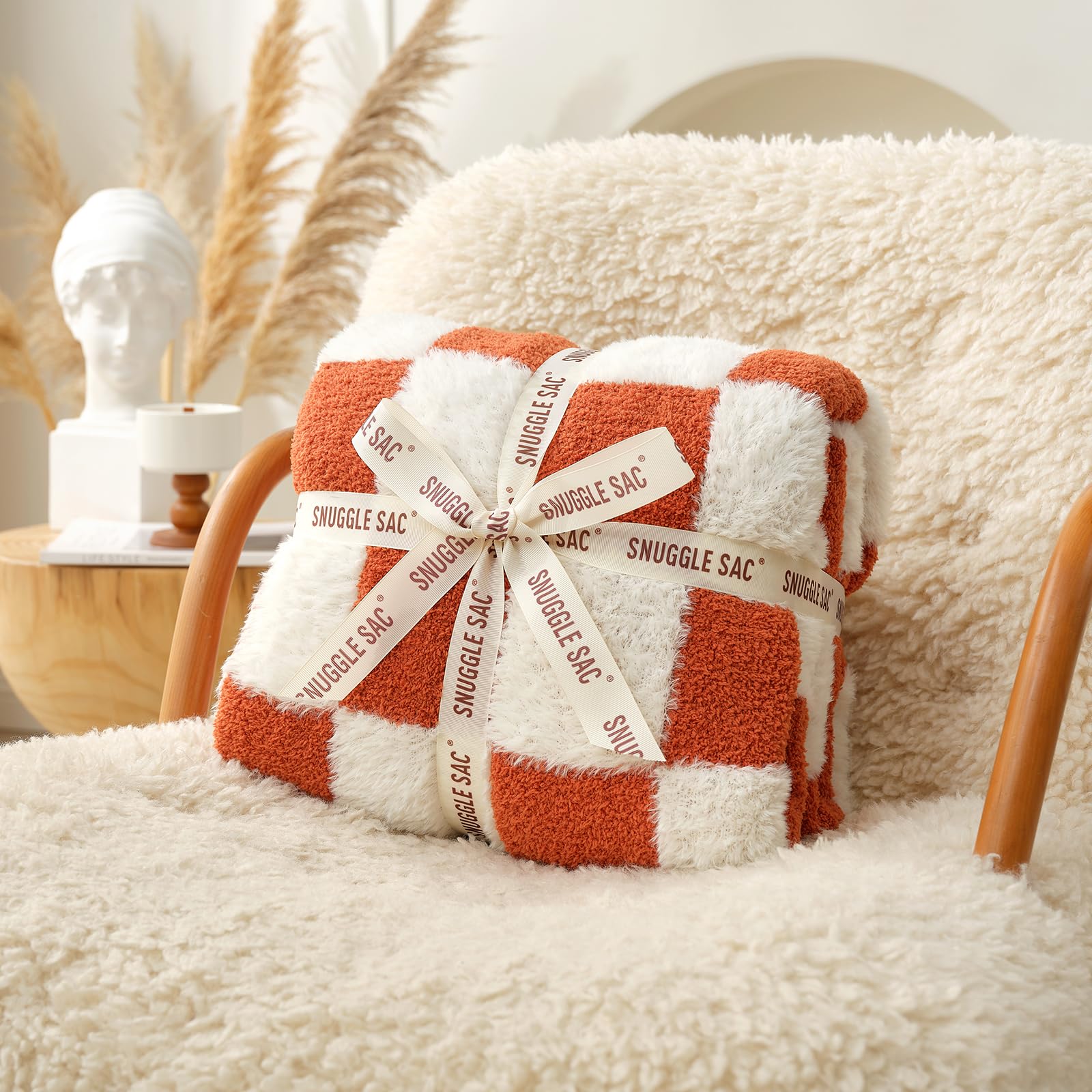 Snuggle Sac orange throw on bed creating warm seasonal bedroom accent