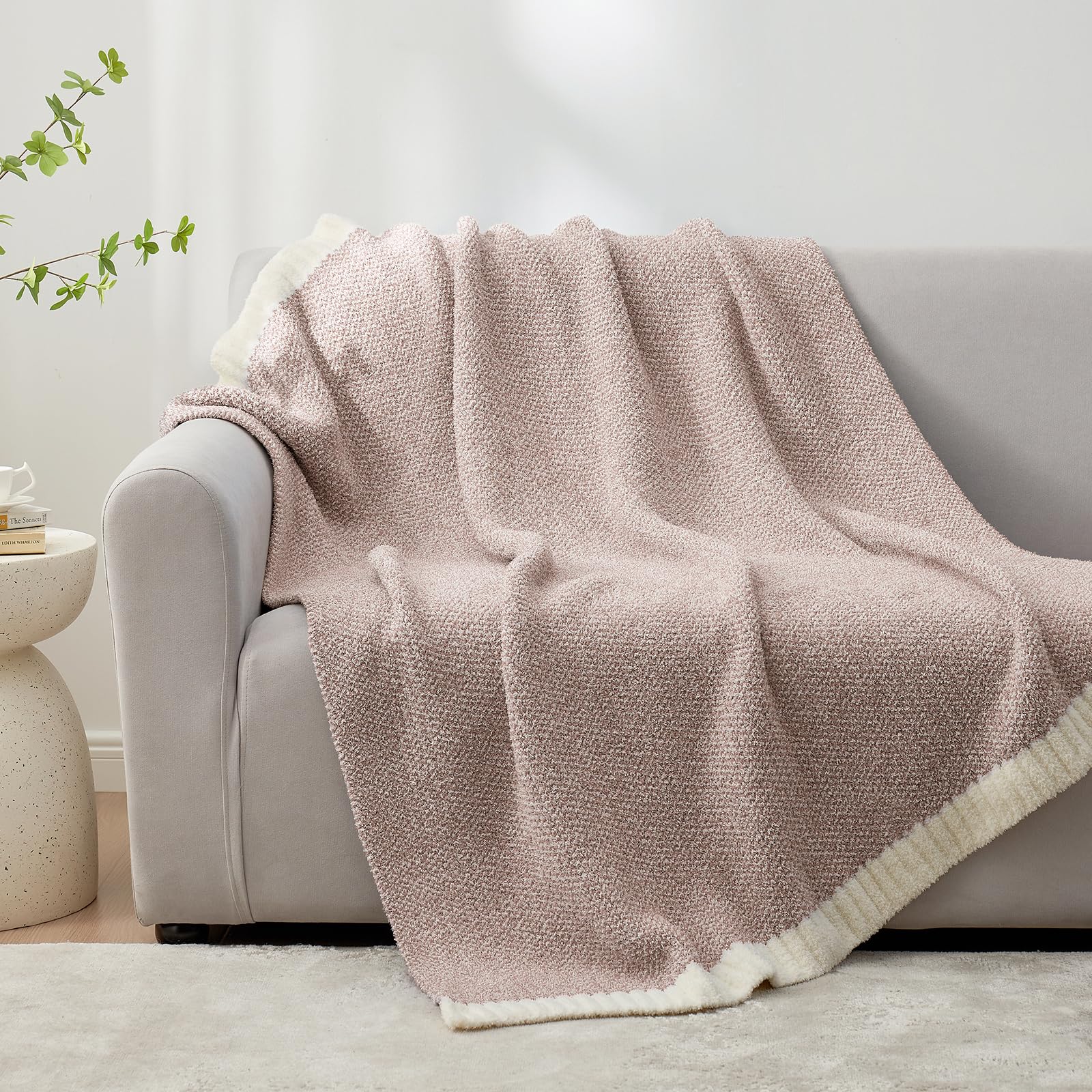 Snuggle Sac folded throw beside book showing compact storage benefit