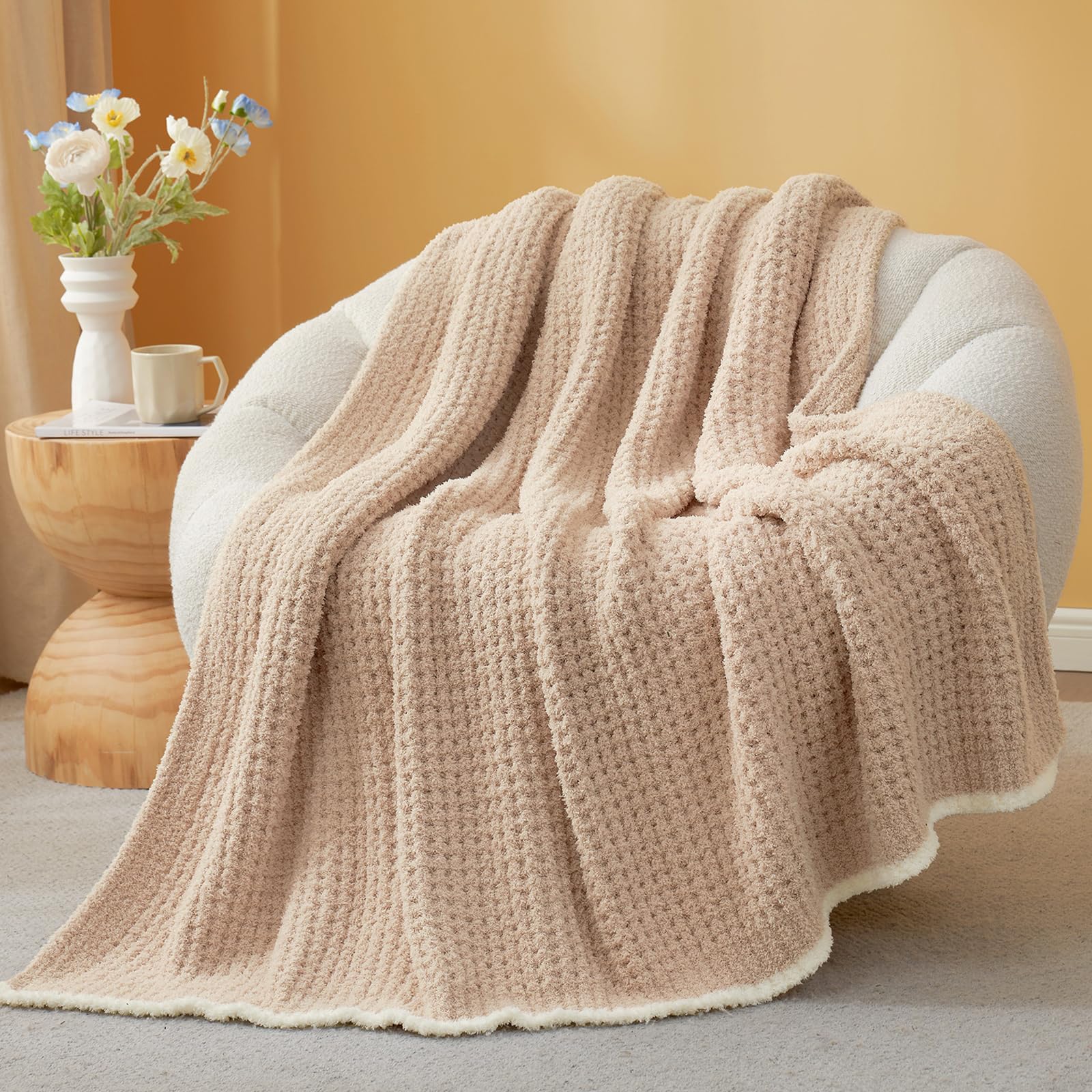 Snuggle Sac throw front view on couch showing beige waffle texture and cozy look