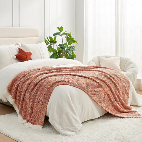 Snuggle Sac orange throw styled on couch adding warm accent