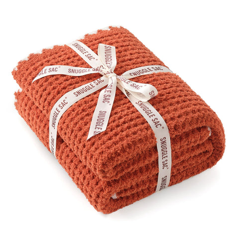 Snuggle Sac orange waffle blanket tied with bow ready as a gift for birthdays and holidays