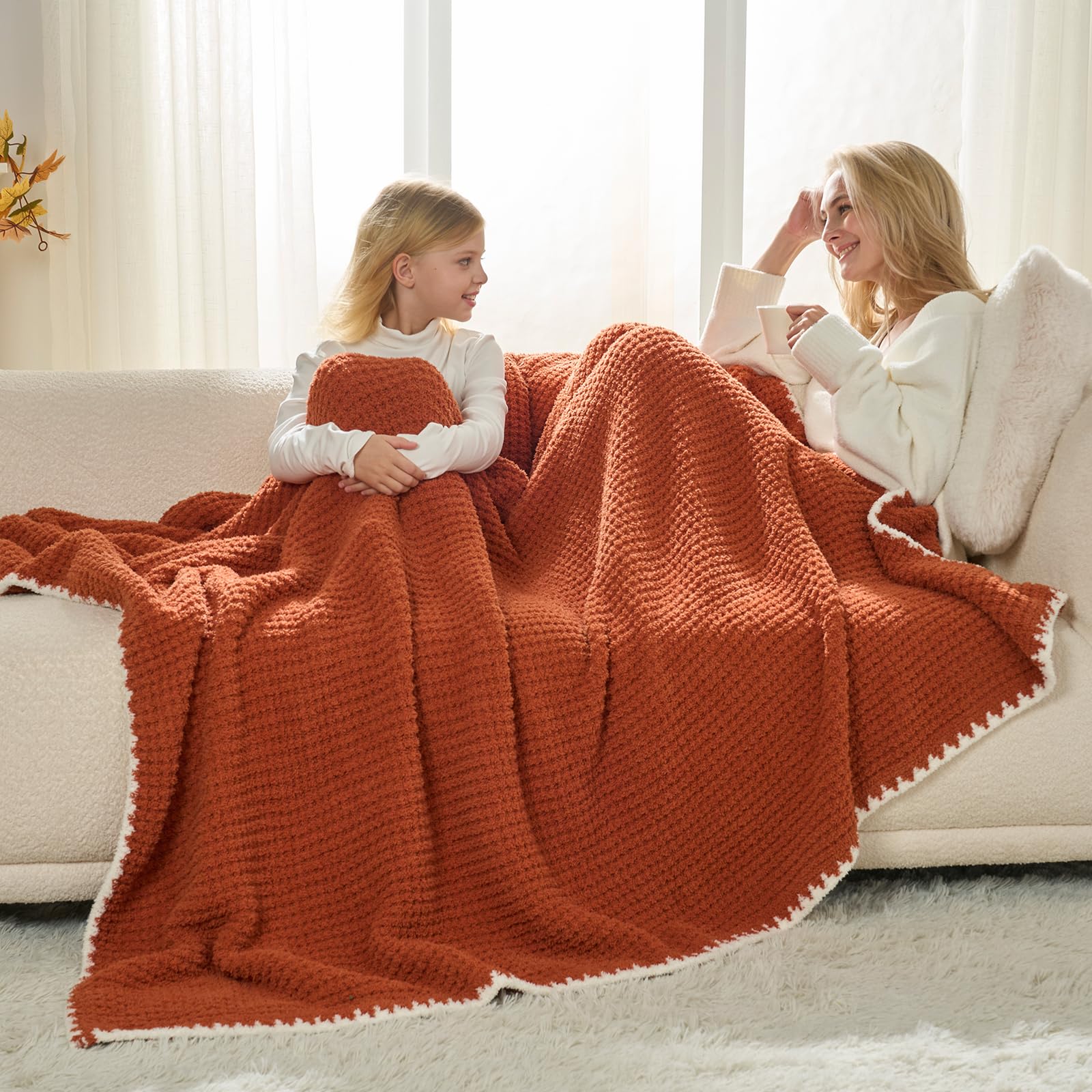 Snuggle Sac blanket draped on sofa in living room demonstrating warm decorative use