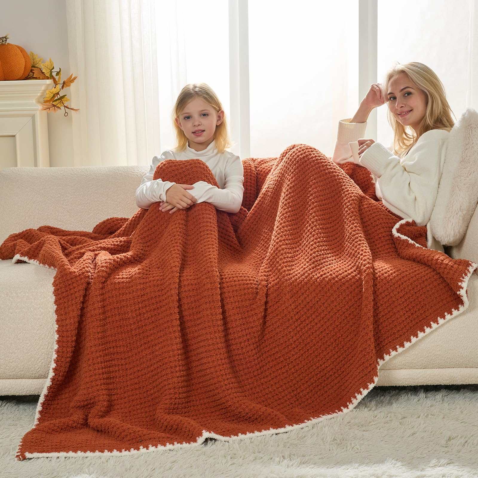Snuggle Sac throw next to a magazine showing 50x60 inch size scale for lap coverage