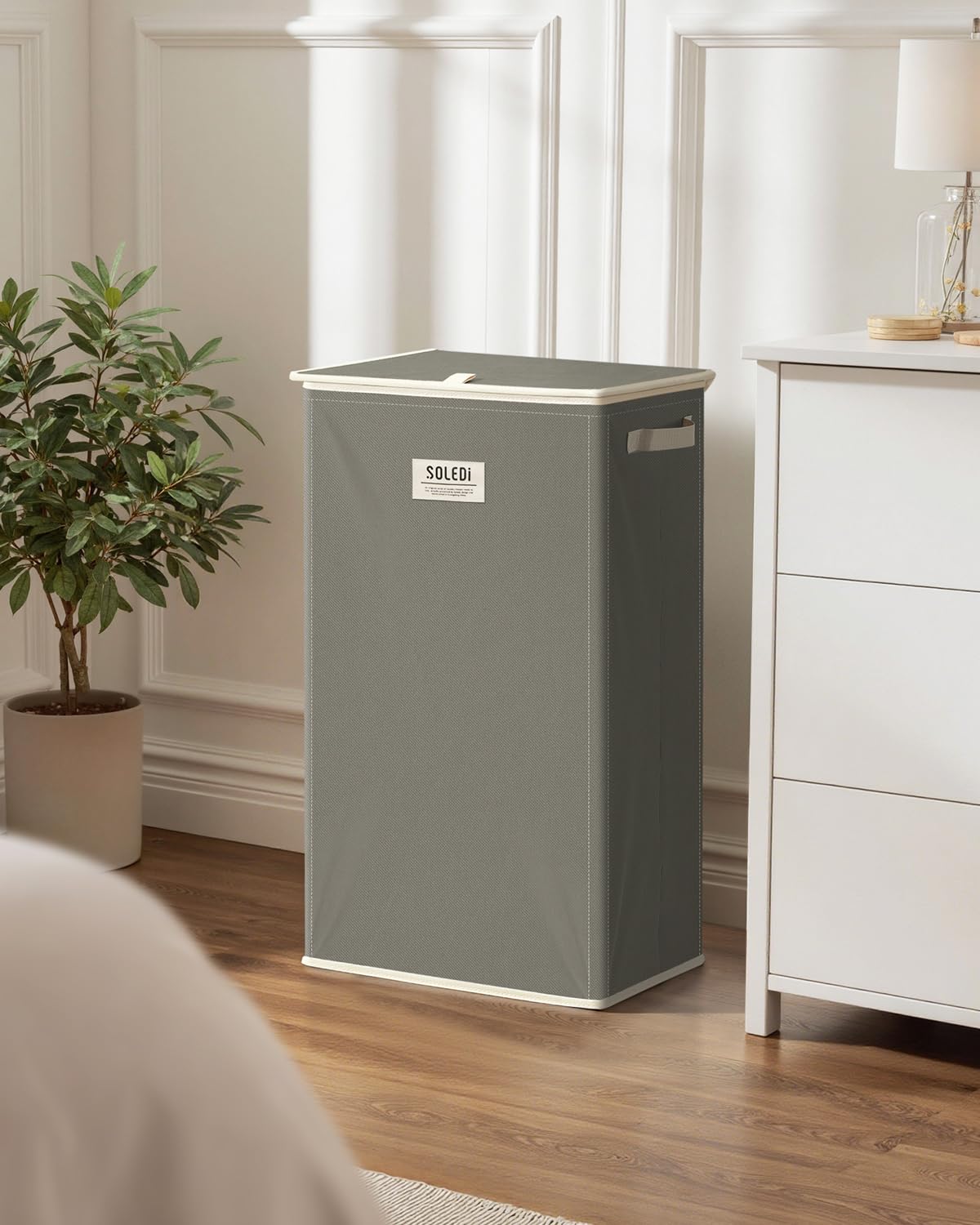 SOLEDI next to chair for scale showing compact vertical footprint