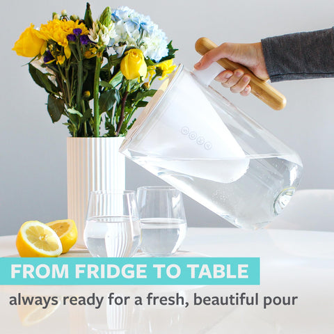 Soma pitcher being poured at a dining table for chilled filtered water