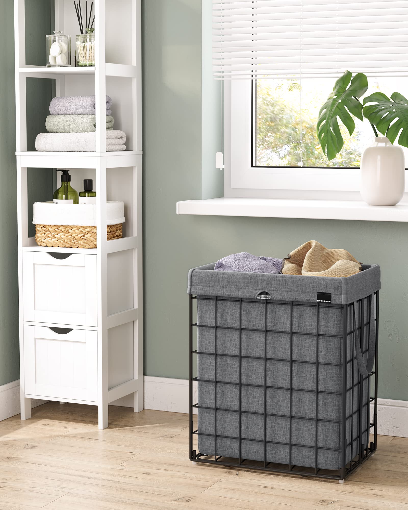 SONGMICS laundry hamper in bathroom setting showing discreet containment benefit