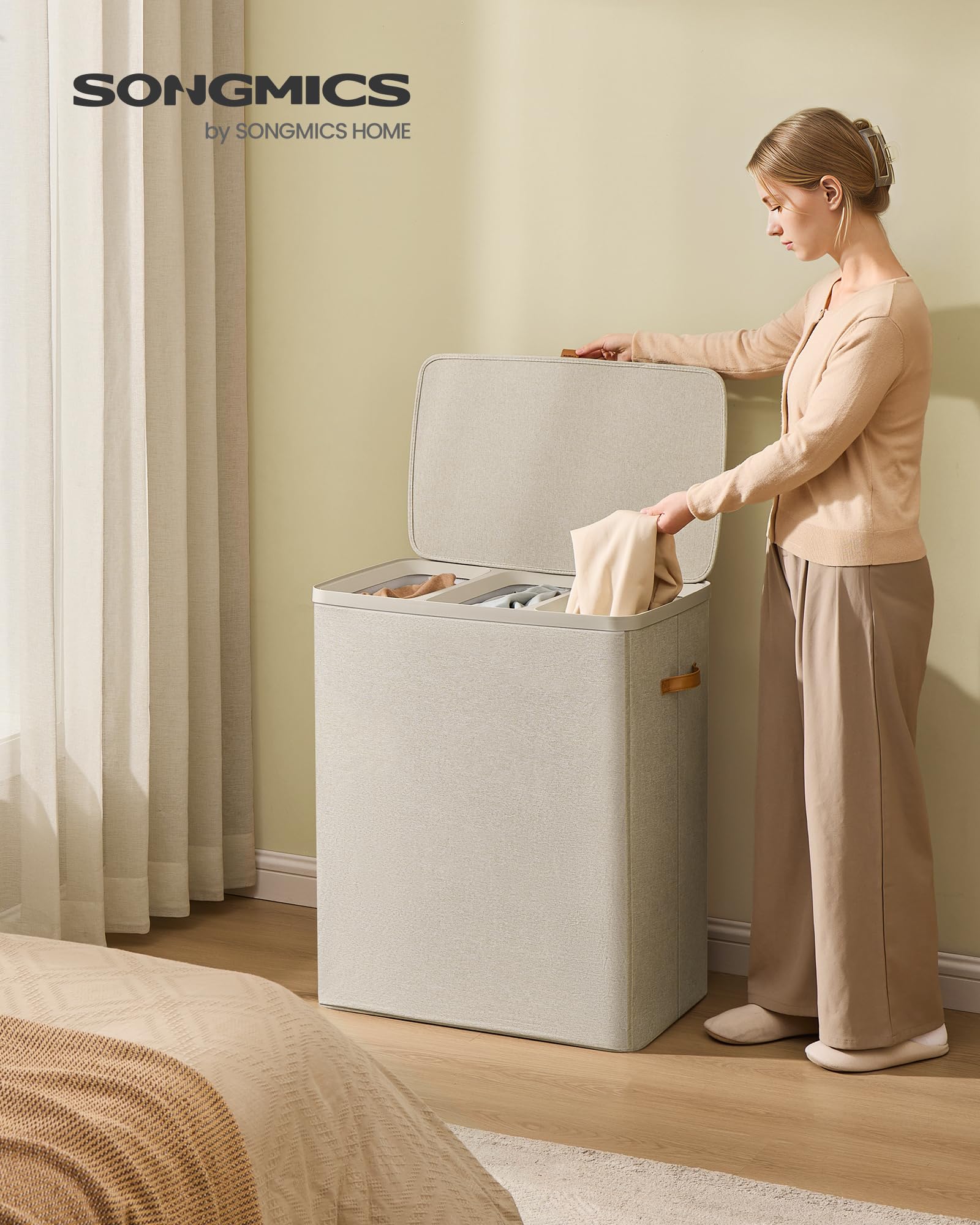 SONGMICS laundry basket with lid open displaying easy access and dust protection