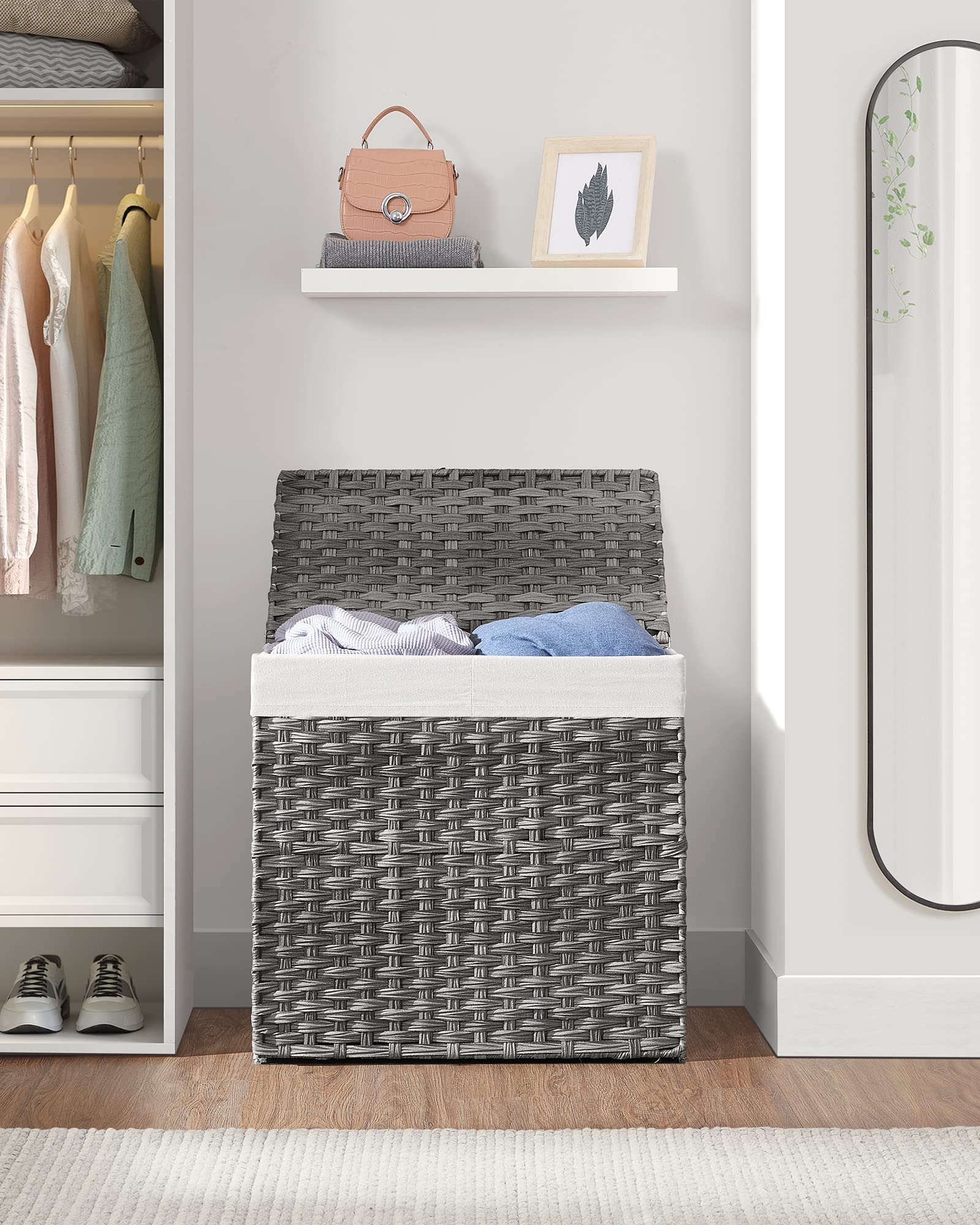 SONGMICS next to chair for scale showing generous 34-gallon capacity benefit