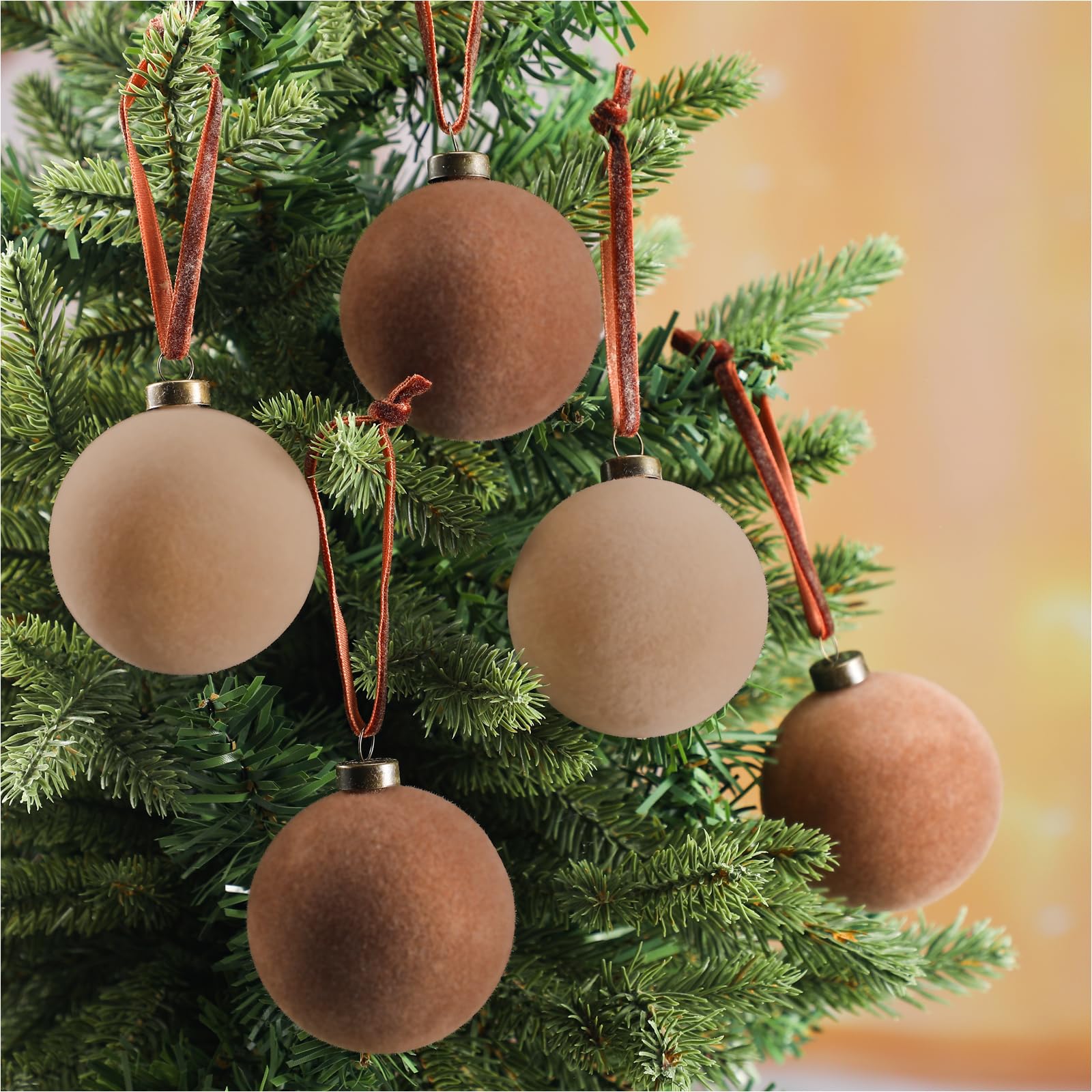 Sotiff hand holding 2.4 inch velvet ornament to show scale and easy placement