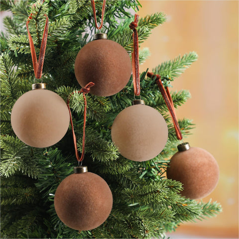 Sotiff hand holding 2.4 inch velvet ornament to show scale and easy placement