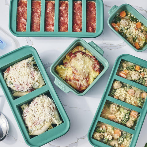 Souper Cubes kale on kitchen counter with prepared meals for fast reheating