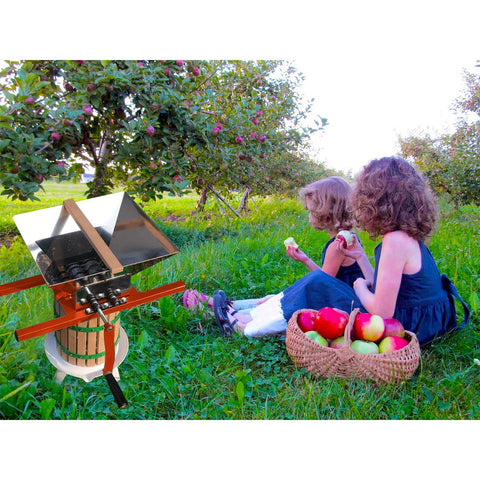 SQUEEZE master in outdoor setting showing portable, power-free fruit crushing benefit
