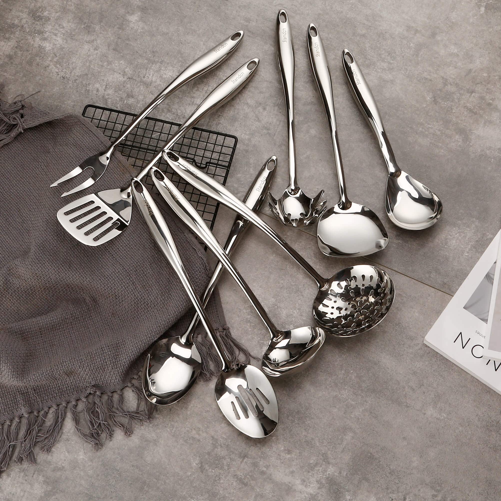 Standcn utensils hanging on wall hooks to save space and display decoratively