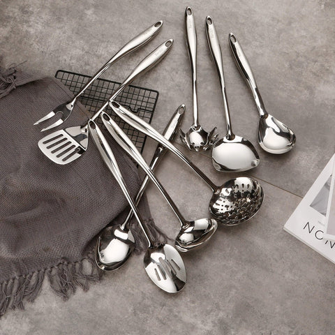 Standcn utensils hanging on wall hooks to save space and display decoratively