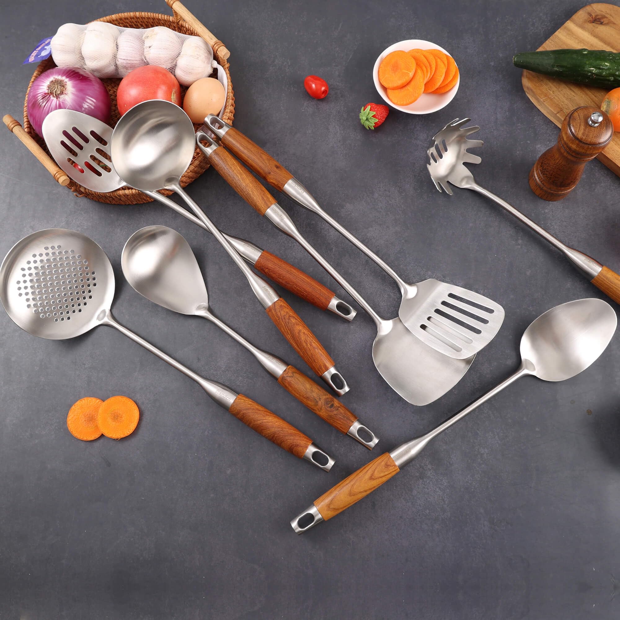 Standcn utensils hung on kitchen rail displaying decorative storage and easy access